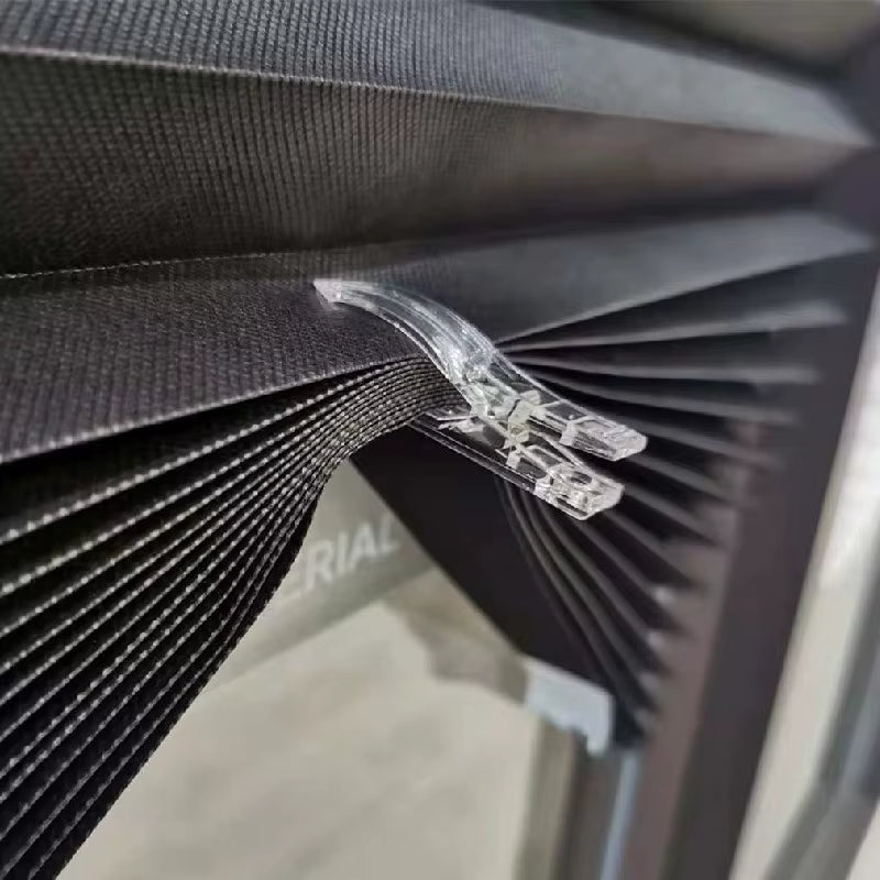 Détail des pinces et bandes adhésives pour fixer un store plissé occultant sans perçage